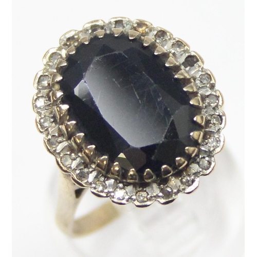 1178 - A large 9ct gold sapphire and diamond cocktail ring, a large central dark blue sapphire surrounded b... 