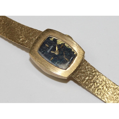 1318 - A vintage 18ct gold Nivada Swiss made watch, the retro bark effect strap and case marked 750 and wit... 