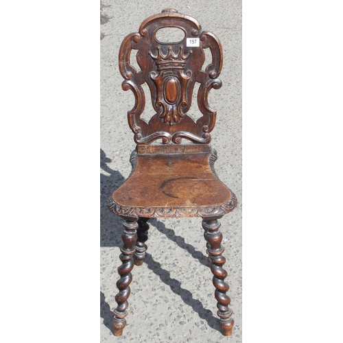 157 - An antique carved oak hall chair with barleytwist legs, approx 85cm tall