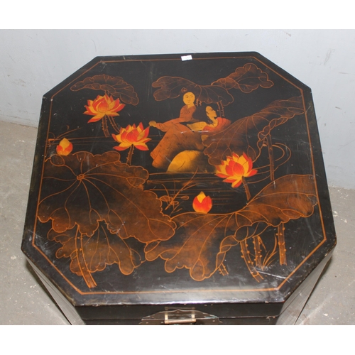 104 - A 20th century Chinese lacquered storage box, with brass handles and locking plate, decorated with w... 