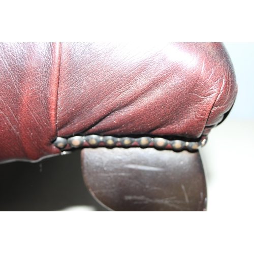 112 - Ox blood Chesterfield style footstool on wooden legs, approx 57 W x 57 D x 32cm H