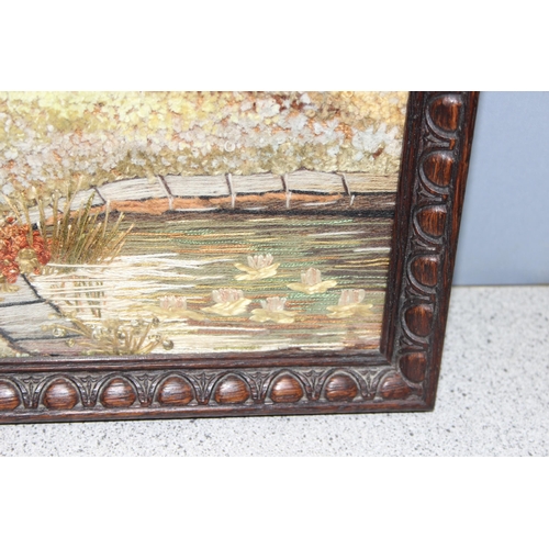 452 - Vintage woven/tapestry type picture of a woodland garden scene in glazed frame, approx 44 x 30cm