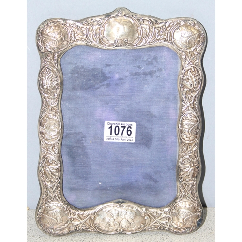 1076 - An Edwardian embossed silver photograph frame decorated with Reynold's Angels, Birmingham 1907 by Bo... 