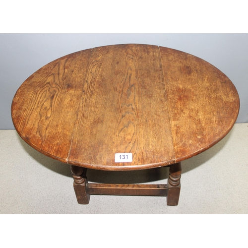 131 - Small vintage oak drop leaf table with swivel top, approx 68cm W x 58cm x 48cm (when open)