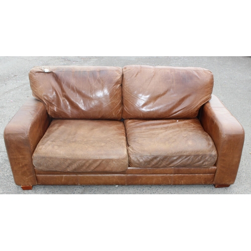 133 - A modern light brown 2 seater leather sofa, approx 202cm wide x 100cm deep x 84cm tall