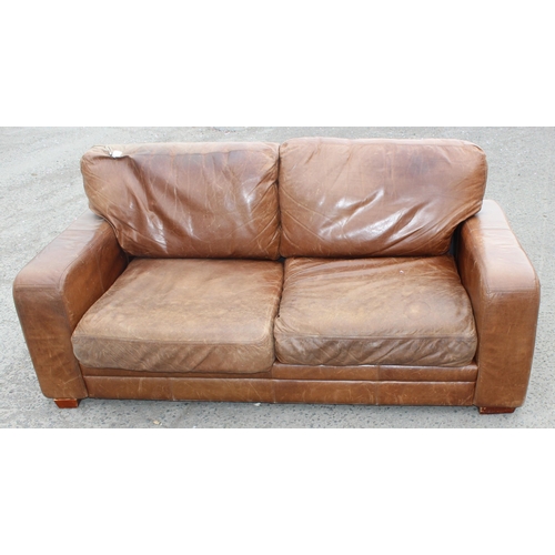 133 - A modern light brown 2 seater leather sofa, approx 202cm wide x 100cm deep x 84cm tall