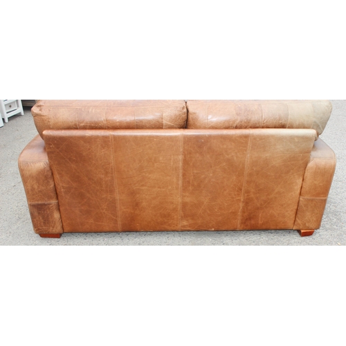 133 - A modern light brown 2 seater leather sofa, approx 202cm wide x 100cm deep x 84cm tall