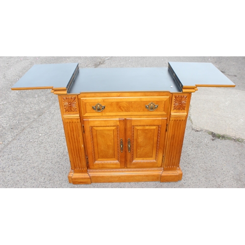 135 - An unusual vintage sideboard with folding serving top and drawer over cupboard base, approx 98cm wid... 