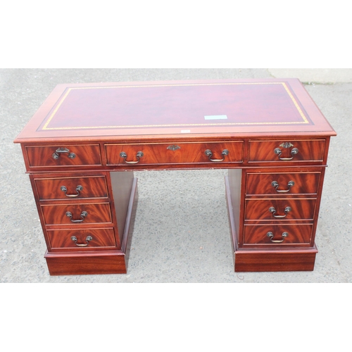 138 - A large antique style mahogany pedestal desk with red leather inset top, approx 137cm wide x 76cm de... 