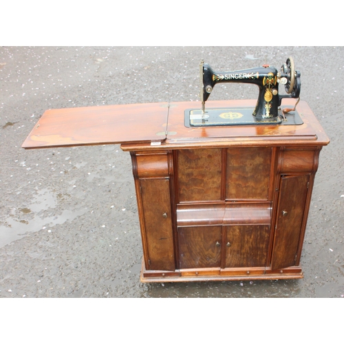 152 - An unusual antique Singer sewing machine cabinet with machine, approx 81cm wide x 45cm deep x 84cm t... 