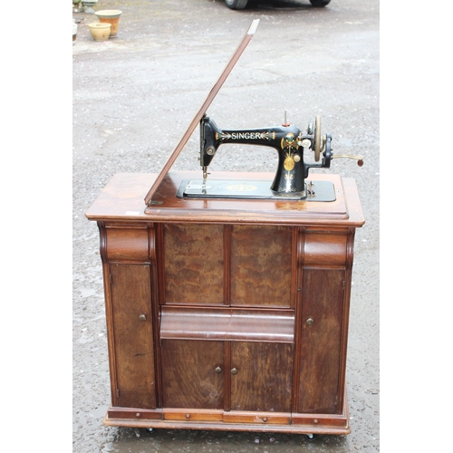 152 - An unusual antique Singer sewing machine cabinet with machine, approx 81cm wide x 45cm deep x 84cm t... 