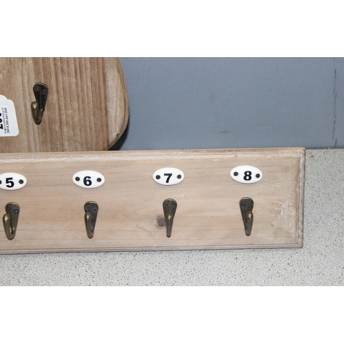 283 - 2 sets of coat hooks on wooden backs, one in the shape of a shield (largest approx 50cm x 4cm)