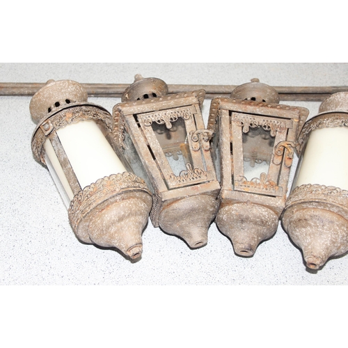 343 - 2 pairs of glazed distressed metal garden candle lanterns with ground stakes