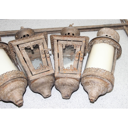 343 - 2 pairs of glazed distressed metal garden candle lanterns with ground stakes