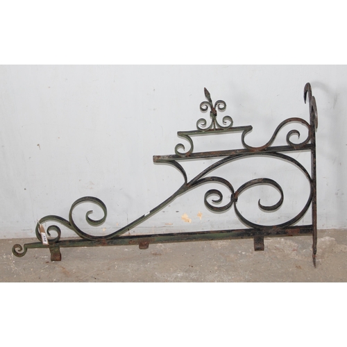 359 - A large vintage wrought iron hanging pub sign bracket, approx 102cm wide x 63cm tall