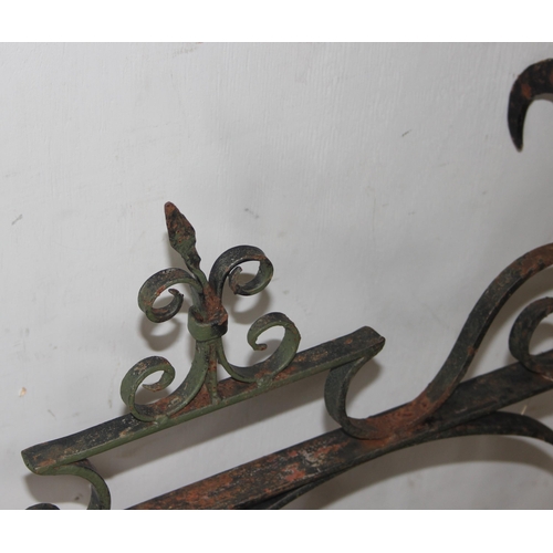 359 - A large vintage wrought iron hanging pub sign bracket, approx 102cm wide x 63cm tall