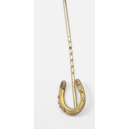 1180 - An antique 9ct gold stick pin formed as a lucky horseshoe, marked 9ct and XRF confirmed, approx 0.84... 