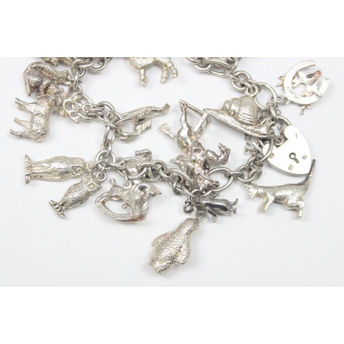 1187 - A good quality vintage silver charm bracelet with a large qty of silver charms, mainly of animals ma... 