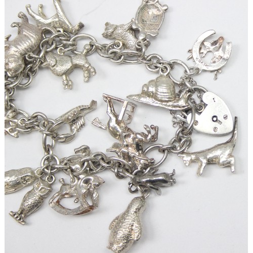 1187 - A good quality vintage silver charm bracelet with a large qty of silver charms, mainly of animals ma... 