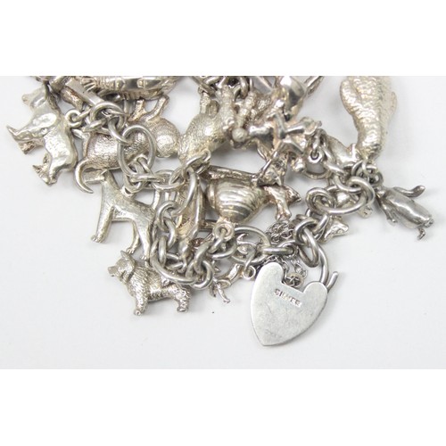 1187 - A good quality vintage silver charm bracelet with a large qty of silver charms, mainly of animals ma... 