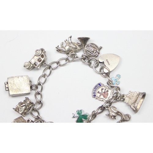 1189 - A good quality vintage silver charm bracelet with a large qty of silver charms to inc a Scooter & Ca... 