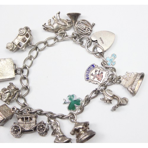 1189 - A good quality vintage silver charm bracelet with a large qty of silver charms to inc a Scooter & Ca... 