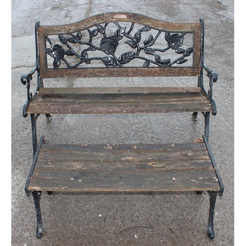 349 - A vintage garden bench with decorative iron back and a matching slatted table, approx 126cm wide x 5... 