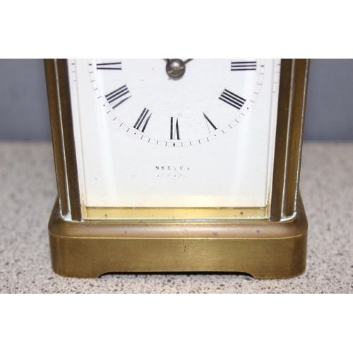 1335 - A vintage brass cased carriage clock, the white enamel dial with Roman numerals marked for Neeves of... 