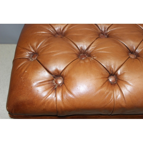 164 - A vintage faux leather light brown Chesterfield style footstool with turned wooden legs, approx 53cm... 