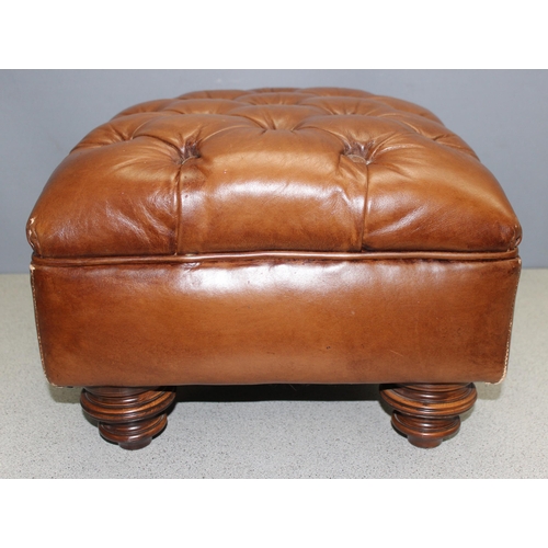 164 - A vintage faux leather light brown Chesterfield style footstool with turned wooden legs, approx 53cm... 