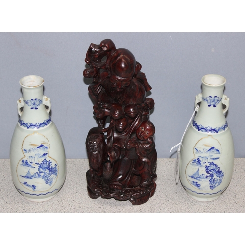 1834 - An Oriental carved wooden figure, approx 27cm tall, and 2 blue & white vases (3)