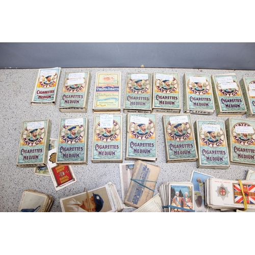 576 - A large qty of assorted cigarette cards, some in vintage Player's Cigarette and other packaging