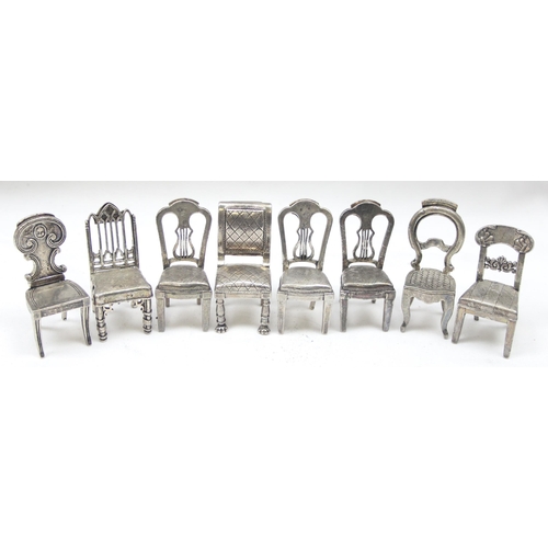 1035 - A set of 8 assorted vintage silver plated menu or place card holders formed as antique chairs to inc... 