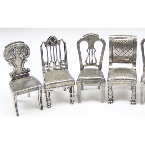 1035 - A set of 8 assorted vintage silver plated menu or place card holders formed as antique chairs to inc... 