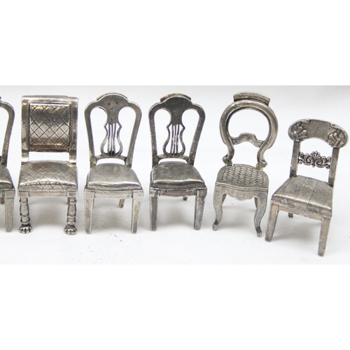 1035 - A set of 8 assorted vintage silver plated menu or place card holders formed as antique chairs to inc... 