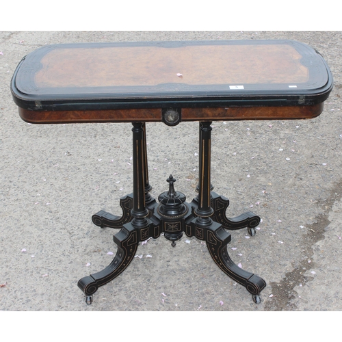 5 - A Victorian burr walnut and ebonised card or games table standing on pillar supports with blue baize... 