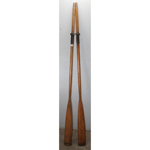 726 - A pair of vintage wooden rowing oars, each approx 234cm long