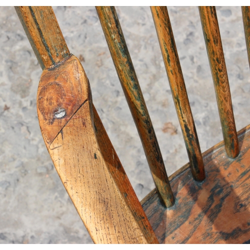 10 - An antique elm seated farmhouse country armchair, late 19th century, approx 87cm tall