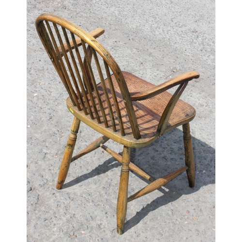 10 - An antique elm seated farmhouse country armchair, late 19th century, approx 87cm tall