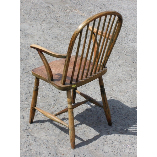 10 - An antique elm seated farmhouse country armchair, late 19th century, approx 87cm tall