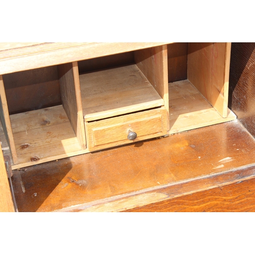 15 - An unusual Art Deco period oak bureau with built-in book shelves, approx 76cm wide x 35cm deep x 100... 