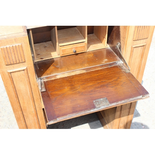 15 - An unusual Art Deco period oak bureau with built-in book shelves, approx 76cm wide x 35cm deep x 100... 