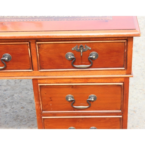 22 - A modern pedestal 3 part desk with red leather inset top, approx 122cm wide x 61cm deep x 78cm tall