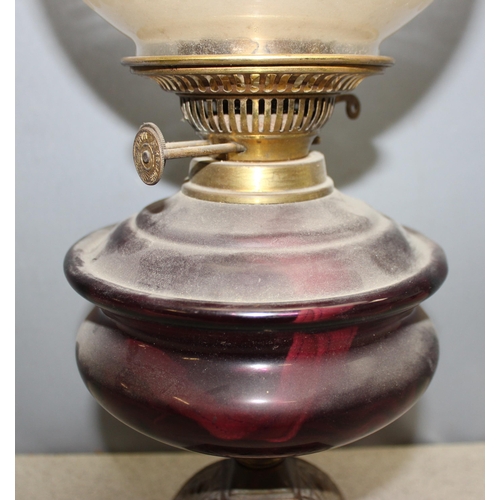 238 - Vintage oil lamp with purple glass oil reservoir, etched shade and chimney flute mounted on decorati... 