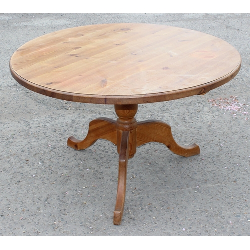 27 - A contemporary circular topped pine dining table, approx 120cm diameter x 76cm tall