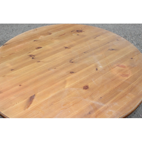 27 - A contemporary circular topped pine dining table, approx 120cm diameter x 76cm tall