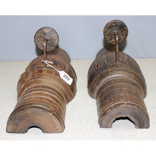 282 - Pair of heavy carved wood candle wall sconces formed from cartwheel hubs, approx 52cm