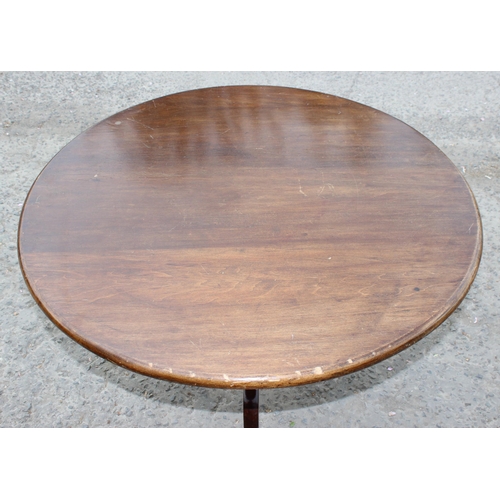 30 - An antique mahogany tilt topped table with tripod base, approx 89cm diameter x 74cm tall