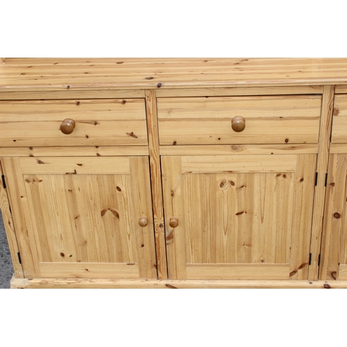 59 - A large glazed pine dresser with 4 cupboards to base, approx 230cm wide x 52cm deep x 221cm tall