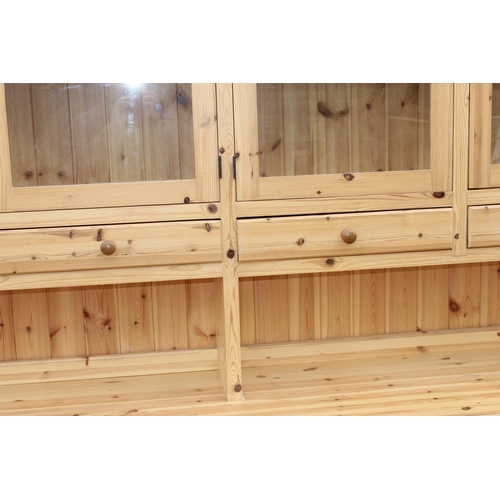 59 - A large glazed pine dresser with 4 cupboards to base, approx 230cm wide x 52cm deep x 221cm tall